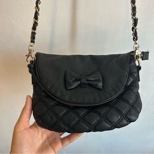 LD quilted black crossbody with bow in the front and gold accents